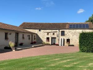 a large stone building with solar panels on the roof at Manoir Les Touches 