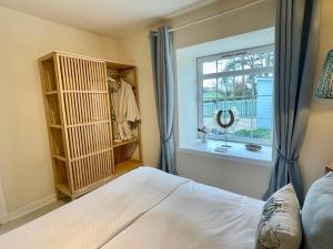 a bedroom with a bed and a window at No 2 Ramageton in Troon