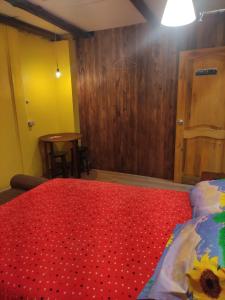 1 dormitorio con 1 cama con edredón rojo en Casa Bella Vista, en Cuenca