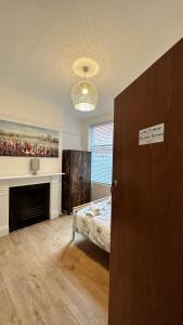 a bedroom with a bed and a fireplace at Victorian/modern house in Newport