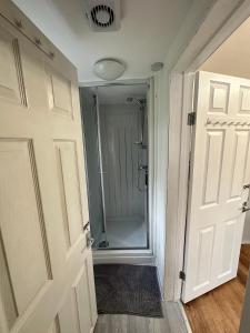 a bathroom with a shower and a glass door at Victorian/modern house in Newport