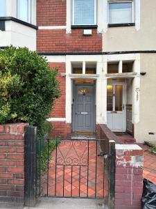 a brick house with a door and a gate at Victorian/modern house in Newport