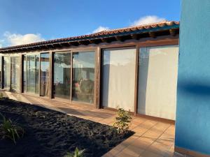 a house with large glass windows on the side of it at Mirador Azul in El Paso
