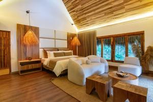 um quarto com uma cama, um sofá e uma mesa em Tewimake Hotel em Santa Marta
