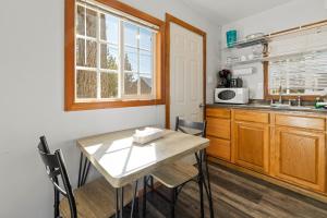 a kitchen with a table and chairs and a window at Baby Bear - A delightful studio style property in the perfect central location! in Big Bear Lake