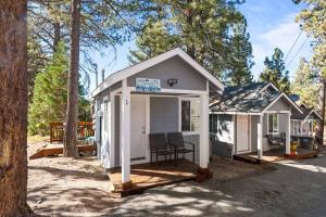 a tiny house with a porch in the woods at Baby Bear - A delightful studio style property in the perfect central location! in Big Bear Lake