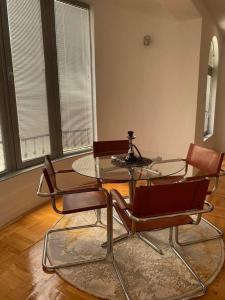 a dining room with a glass table and chairs at Luxury apartment in Bitola