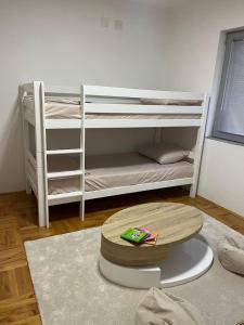 a room with two bunk beds and a rug at Luxury apartment in Bitola