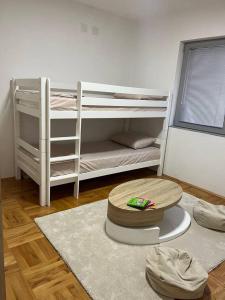a room with two bunk beds and a rug at Luxury apartment in Bitola