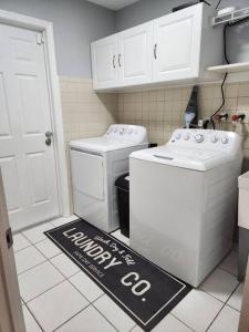 a kitchen with a happy birthday sign on the floor at Home Away from Home with Heated Pool in New Port Richey +11 photos