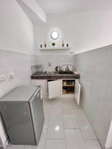 a small kitchen with a counter and a refrigerator at Studio de charme Centrale Rabat in Rabat