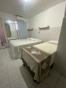 um quarto com duas camas e um lavatório em Temporada CG - Casinha da Vovo em Campina Grande