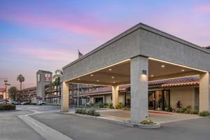 a building in a parking lot next to a street at Best Western Plus Executive Inn in Rowland Heights