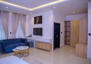 a living room with a blue couch and a table at Elcastillo Homes in Lagos