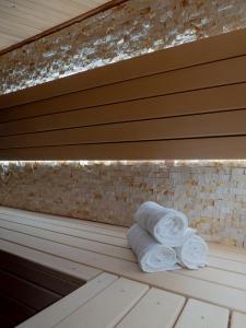 a stack of towels sitting on a bench at Luxurious Family Villa with sauna big garden and jacuzzi in Zeewolde