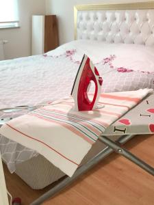 a large bed with a red object on it at Koza Apartment, next to Akbati Shopping Mall and Tennis court Soul Entertainment in Istanbul