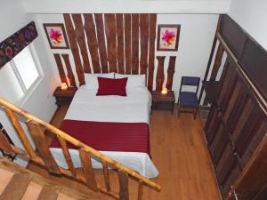 a bedroom with a bed and a staircase at La Molienda Casa Hotel in San Agustín