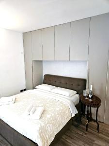 a bedroom with a large bed and a table at Heart of Brera in Milan