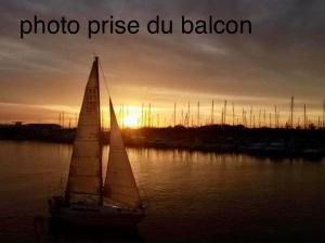 a sail boat in the water with the sunset in the background at LE PANORAMIQUE cap d’agde in Cap d'Agde
