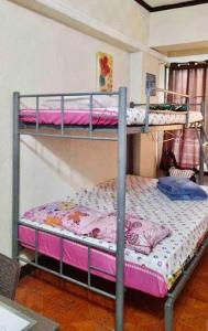 a couple of bunk beds in a room at Baguio Breeze Condo2 in Baguio