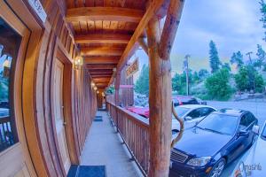 a covered porch of a building with a car parked at Hotel Rio Vista in Winthrop