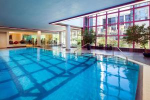 a large pool with blue water in a building at Sheraton Vancouver Wall Centre in Vancouver