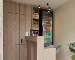 a kitchen with a refrigerator with drinks in it at Elemont Hotel in Medellín