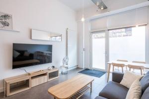 a living room with a couch and a table at L'Atelier Loft-Invalides Tour Eiffel- 6 pers-2 Chambres - Cosy in Paris