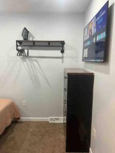 a room with a flat screen tv on a wall at Two bedrooms with parking & washer/dryer in Schenectady