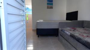 a bedroom with a bed and a bed frame at Pousada Lagoinha in Ubatuba