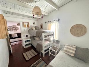 a bedroom with a bed and a couch in a room at Casa divina temporaria en Tafí Del Valle ,pleno centro in Tafí del Valle