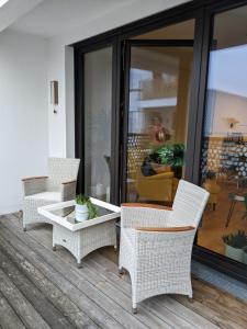 d'une terrasse avec des chaises en osier et une table. dans l'établissement Luxury, Spacious, Sunny home in the heart of Berlin, à Berlin