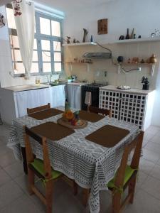 a kitchen with a table with a tablecloth on it at Kaza Jindung in Mindelo
