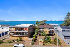 an aerial view of a house with the ocean in the background at Peninsula Waters Unit 14 Soldiers Point Road 2 in Soldiers Point