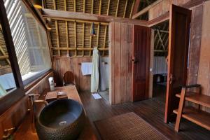 a bathroom with a black tub in a room at Jeeva Beloam Beach Camp in Tanjung Ringgit