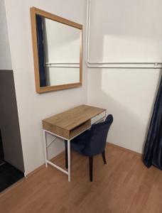 una scrivania con specchio e sedia in camera di Apartma Pekrska vila a Limbuš