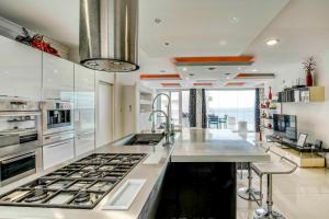 a kitchen with a stove and a counter top at Oceanfront 3BR Penthouse Luxury & Views in Sliema in Sliema