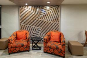 two chairs and a table in a waiting room at Baymont by Wyndham McAllen Pharr in McAllen