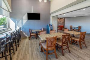 a restaurant with tables and chairs and a bar at Baymont by Wyndham McAllen Pharr in McAllen
