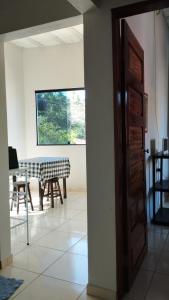 an open door to a dining room with a table at Flat Japaratinga Beach in Japaratinga