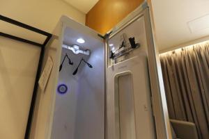 a shower in a bathroom with a door with a mirror at Brooks Business in Changwon