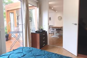 a bedroom with a bed and a desk and a mirror at Private Self Contained Annex/Cabin in Birmingham