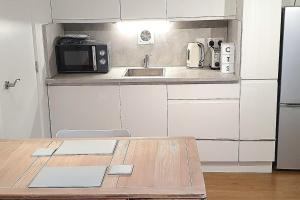 a small kitchen with a sink and a microwave at Private Self Contained Annex/Cabin in Birmingham