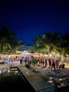 a group of people playing on the beach at night at Bella's Backpackers Hostel in Caye Caulker