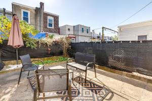 a patio with two chairs and a table and an umbrella at Philadelphia Vacation Rental about 4 Mi to Center City in Philadelphia