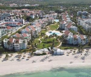 an aerial view of a beach with houses and the ocean at Oceanfront Playa Turquesa with highspeed Wi-Fi, pools, free beach access in Punta Cana
