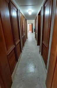 a long hallway with wooden doors and a hallwayngth at Oceanfront Playa Turquesa with highspeed Wi-Fi, pools, free beach access in Punta Cana
