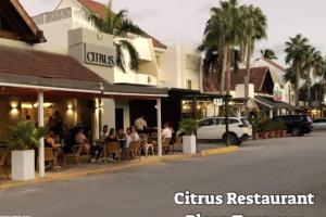 a group of people sitting at tables outside a restaurant at Oceanfront Playa Turquesa with highspeed Wi-Fi, pools, free beach access in Punta Cana