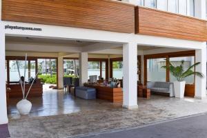 a lobby of a building with glass doors and a lobby at Oceanfront Playa Turquesa with highspeed Wi-Fi, pools, free beach access in Punta Cana