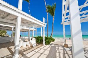 a view of the beach from the patio of a beach house at Oceanfront Playa Turquesa with highspeed Wi-Fi, pools, free beach access in Punta Cana